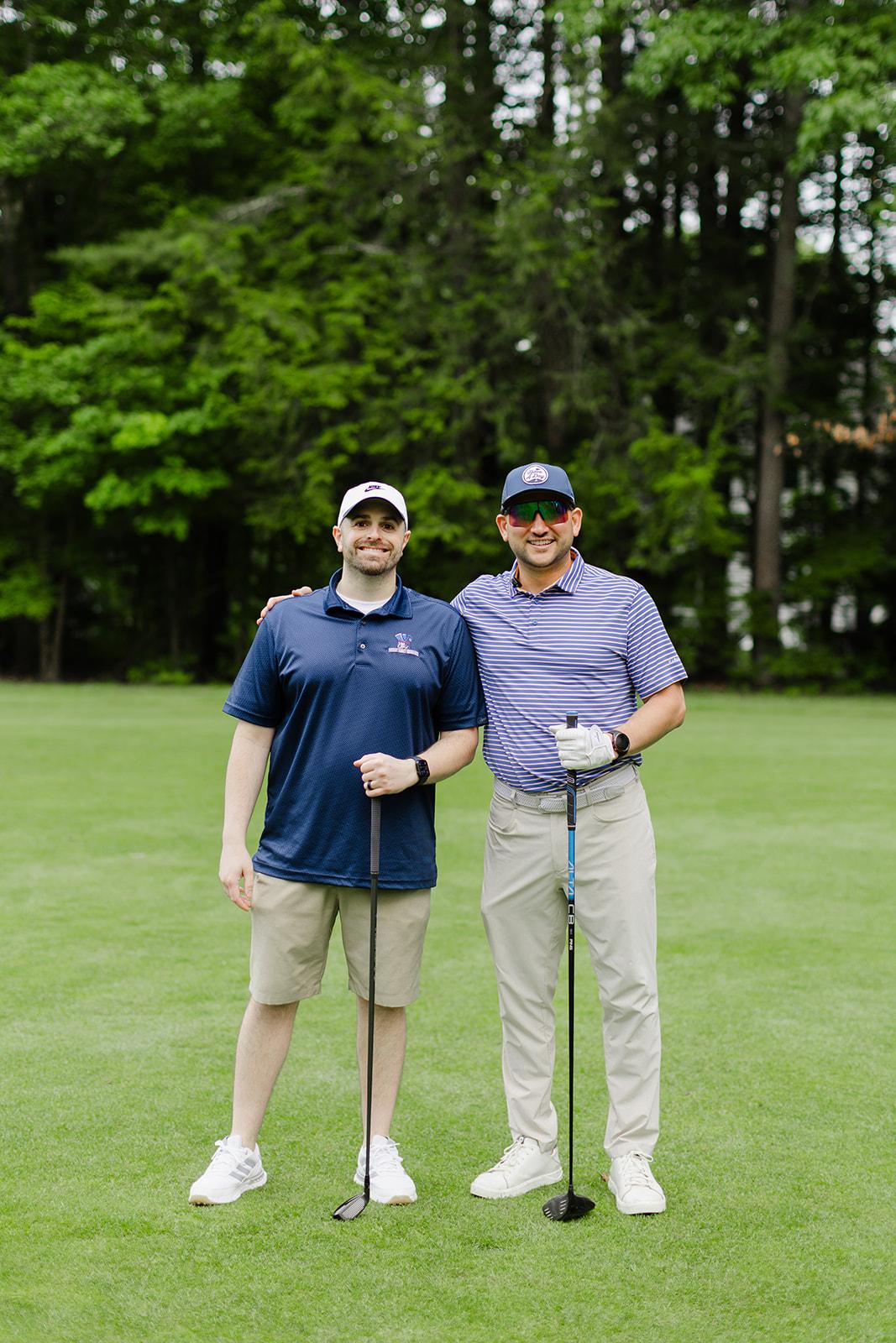 Two Patriot team members ready to drive on a sunny day on the course