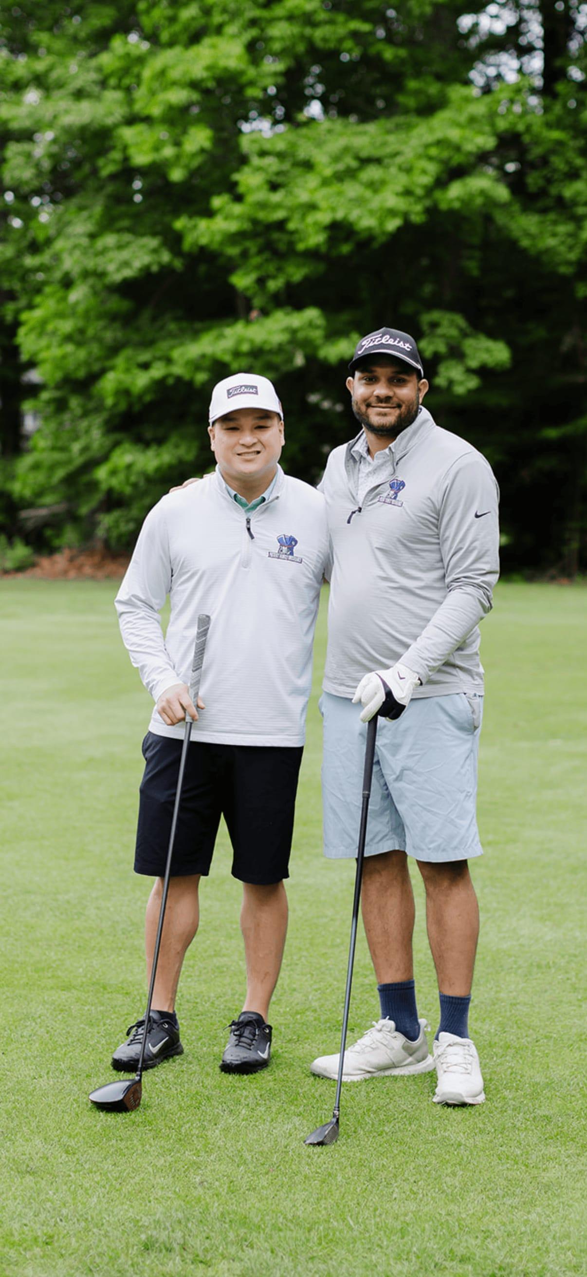 Two Patriot teammates posing together on the fairway